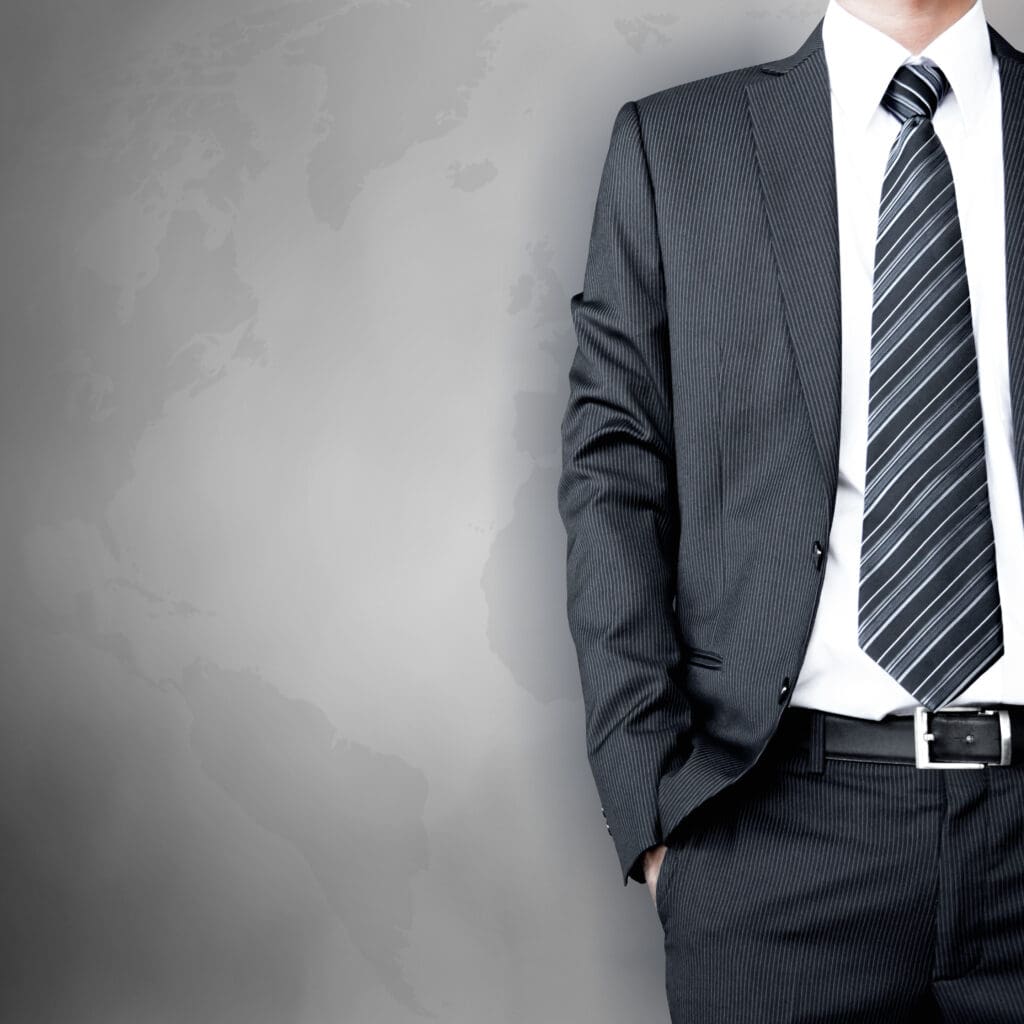 Man standing in a suit with a striped tie